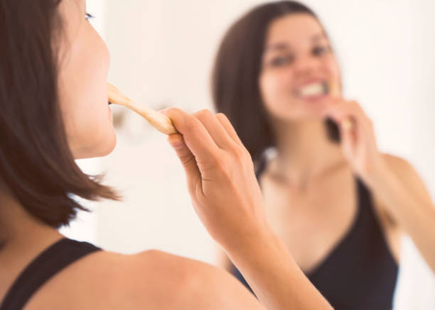 istock Woman carefully looks after her teeth. 1360846658