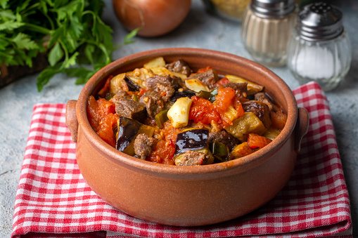 Top view of Turkish dish Guvech - baked meat with eggplant and traditionally served in earthenware pot (Turkish name; etli patlican guvec)