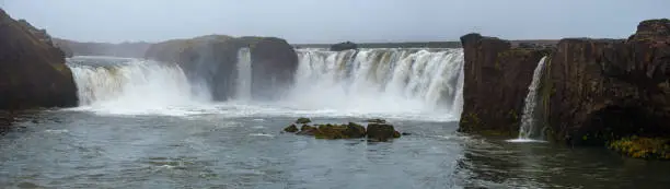 Picturesque full of water big waterfall Goðafoss autumn dull day view, north Iceland.
