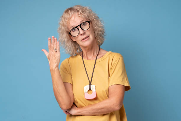 istock Angry emotional mature woman screaming on blue studio background. 1360852030