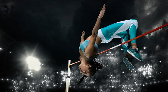 Mujer en acción de salto de altura. Banner deportivo photo