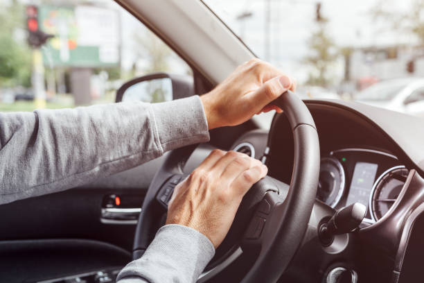 Angry annoyed driver pushing car horn on steering wheel stock photo