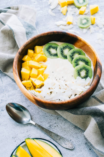 istock Healthy fruit smoothie bowl with mango, coconut chips and kiwi. 1360854762
