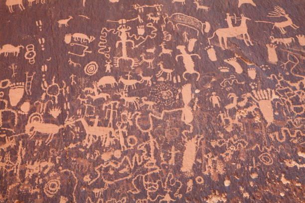 Rock panel covered with one of the largest known collections of ancient petroglyphs at Newspaper Rock Historical  Monument in Utah Rock panel covered with one of the largest known collections of ancient petroglyphs at Newspaper Rock Historical  Monument in Utah anasazi stock pictures, royalty-free photos & images