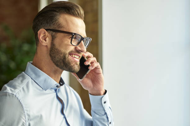 Mirthful man enjoying pleasant conversation and smiling