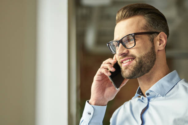 istock Gladsome handsome man feeling happy at the phone talk 1360855992