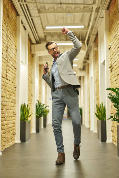 istock Excited male office worker celebrating his success 1360856033