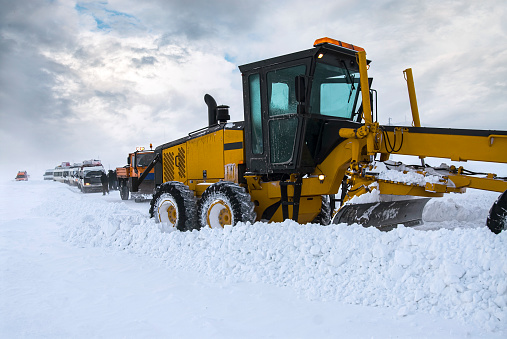 Construction machine trying to open the highway that was closed due to a snowstorm.