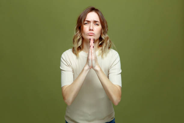istock Young woman begging for mercy make praying gesture. Female imploring appealing, asking for forgiveness, feeling sorry 1360857927