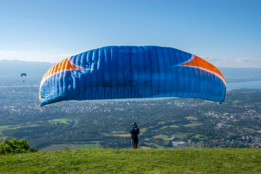 The aviator is preparing to take off like a leader who shows the way, responsibilities, success, hard working. A wonderful landscape and the pilot is ready to take off for paragliding.