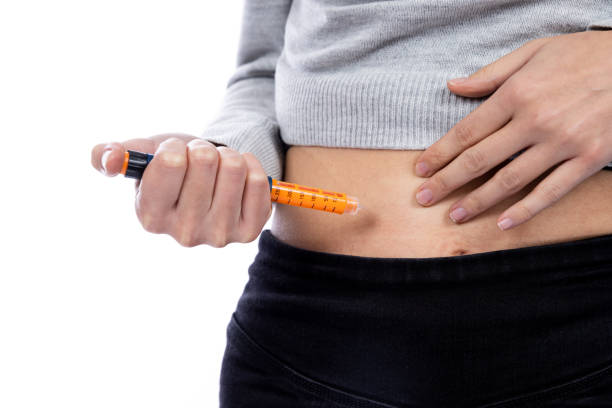 istock young woman injecting insulin into her belly 1360858669