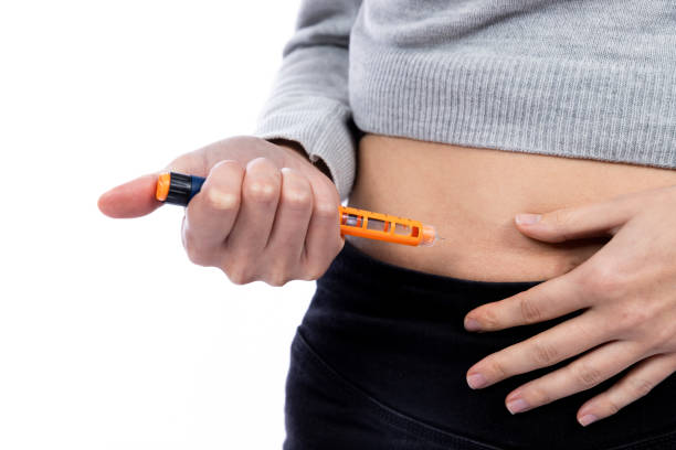 istock young woman injecting insulin into her belly 1360858670