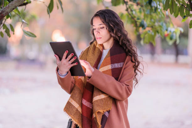 Spanish businesswoman confident entrepreneur with tablet touchscreen in Toledo. fall colors stock photo