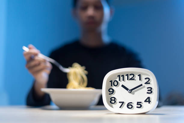 Man eating late night time alone at home or apartment scene.