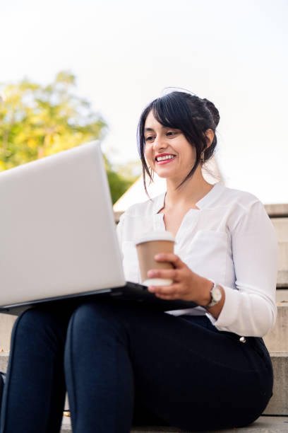 istock businesswoman working with computer in a city park 1360866828