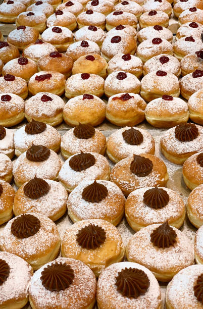 istock Hanukkah Sufganiyot Donuts Chocolate Jelly Pattern Doughnut Food Background In a Row Bakery Shop Israeli Culture Tradition Jewish Food Texture 1360867743