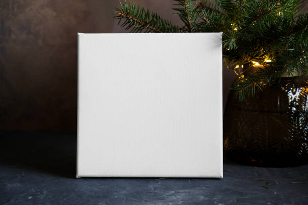 istock Blank canvas and Christmas tree twigs 1360868277