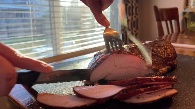 Slicing Turkey For Dinner With Family In Sunny Dining Room