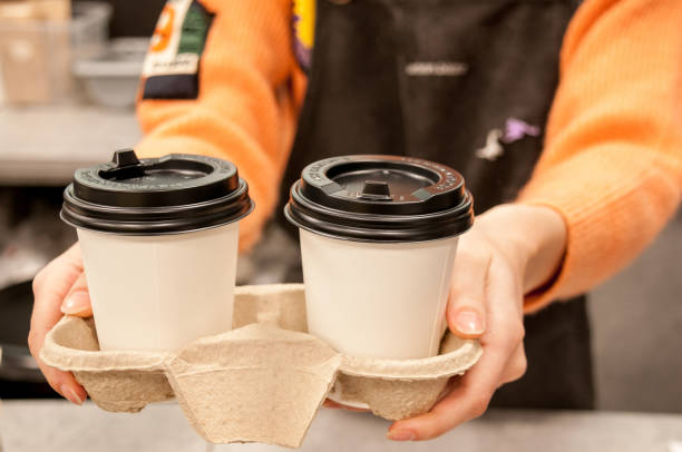 istock Barista girl serves two takeaway cafes 1360886721