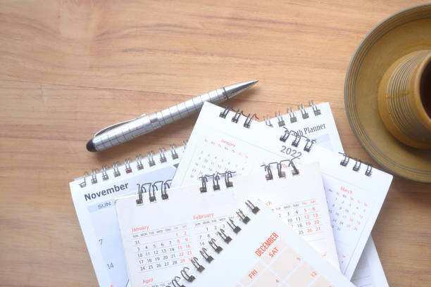 istock tack of calendar and cup of tea on table 1360894049