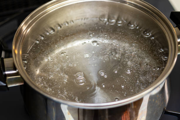 istock Water bubbling in a metal pot 1360896779