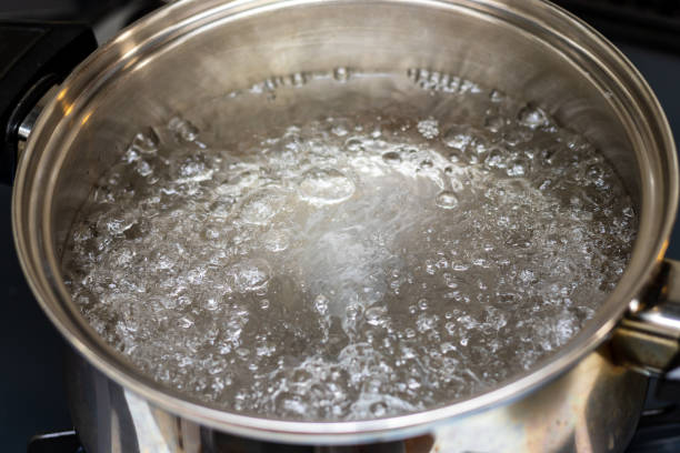 istock Water boiling violently in a metal pot 1360896792