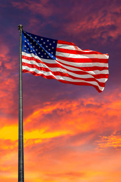 istock USA flag waving against sunset sky 1360903467