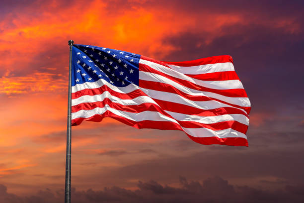 istock USA flag waving against sunset sky 1360903469