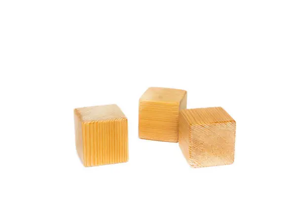 three natural wooden toy blocks isolated on white background