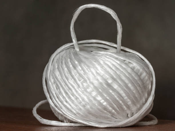 a ball of polypropylene strong rope for crafts or bundling of bundles, one turn raised up, a ball of polypropylene strong rope for crafts or wrapping and strapping bundles, one turn up, selective focus polypropylene stock pictures, royalty-free photos & images