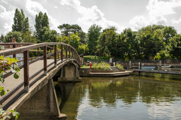 Footbridge over the River Thames at Marlow Lock, Buckinghamshire on a sunny summer afternoon.