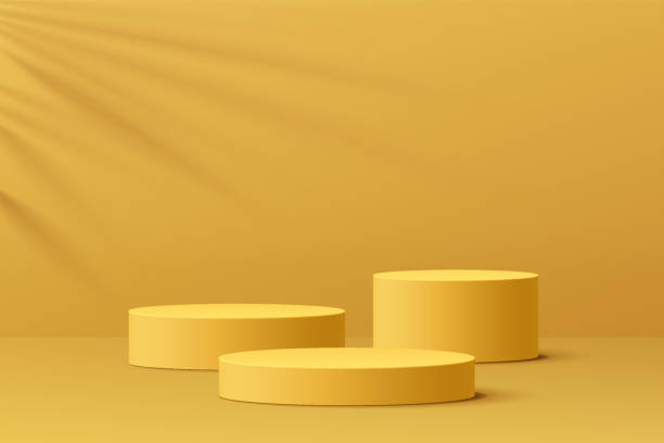 istock Realistic yellow 3D cylinder pedestal podium set with leaf shadow overlay. Minimal scene for products showcase, Promotion display. Vector abstract studio room platform design. Stage for showcase. 1360915880