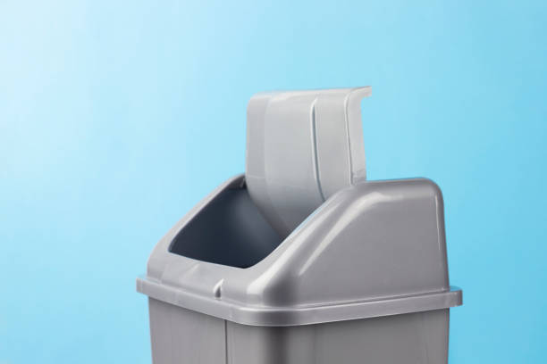 gray trash can lid on blue background