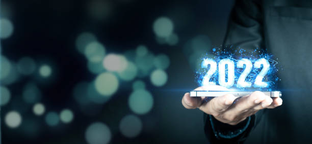 istock Businessman holding virtual 2022 number. 1360922488