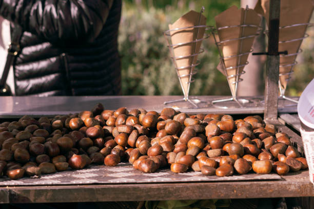 Raw chestnuts prepared for roasting for sale at a market