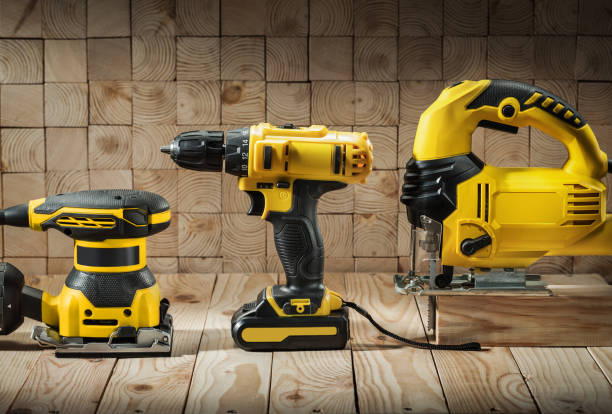 istock construction carpentry tools electric corded jigsaw cordless drill and wood sander on wooden background 1360923778