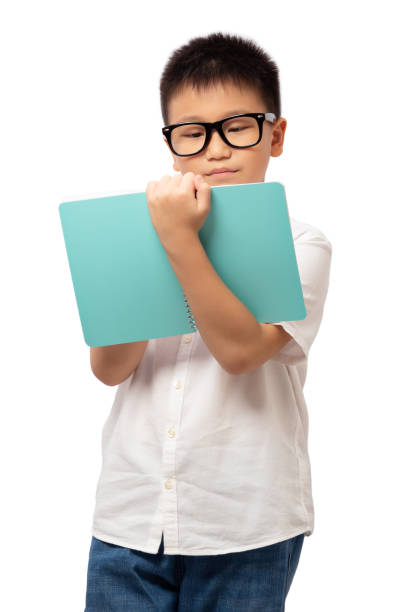 istock Kid wearing glasses reading and holding book 1360924475