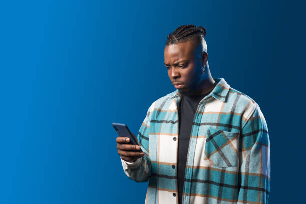 istock Handsome black man looking at mobile worried. 1360924967