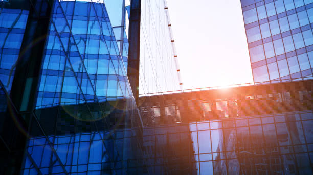 istock Modern office building with glass facade on a clear sky background. 1360925680