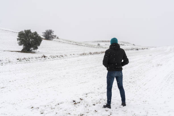 istock Person from behind in a snowy landscape. 1360926630