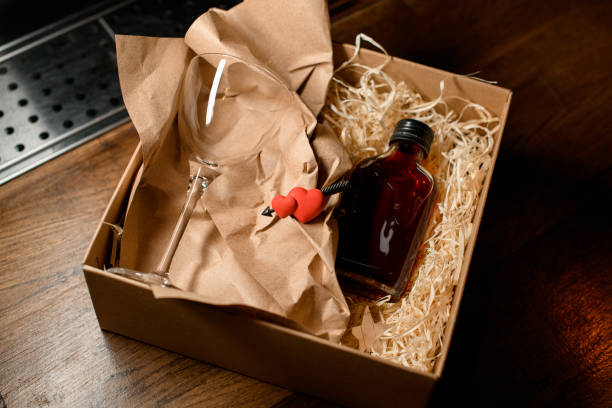istock cardboard box with glass and a small bottle with drink and a decorative heart 1360927501