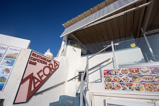Cafe Zafora in Firá on Santorini, Greece, with commercial images of food in the background