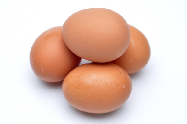 istock Photo of four eggs stacked on a white background 1360933162