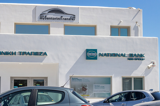 National Bank of Greece on Santorini in South Aegean Islands, Greece, with commercial posters visible