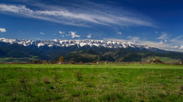 Serra del Cadí range seen from Lles de Cerdanya in spring (Cerdanya, Catalonia, Spain, Pyrenees) stock photo