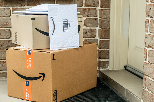 Sydney, Australia - 2021-12-03 Amazon prime boxes and envelopes delivered to a front door of residential building. Black Friday Cyber Monday Christmas Sale Prime Day. Amazon Flex delivery