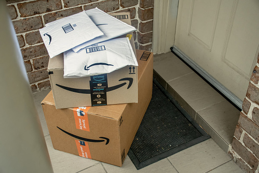 Sydney, Australia - 2021-12-03 Amazon prime boxes and envelopes delivered to a front door of residential building. Black Friday Cyber Monday Christmas Sale Prime Day. Amazon Flex delivery