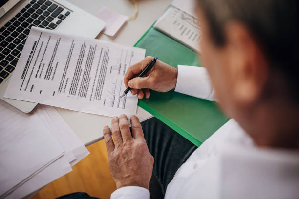 istock Signing a paper document in the office 1360941219