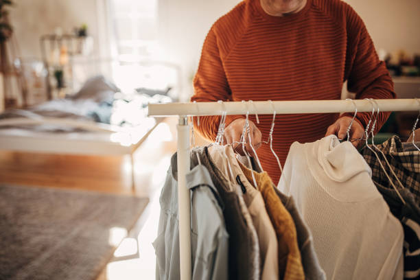 istock A man chooses clothes at home 1360941916