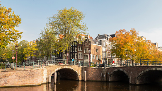The Amsterdam canals, bridges and canal houses in the autumn season; Netherlands.